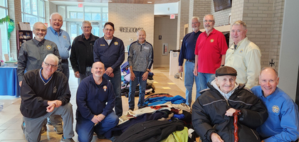 Knights from St. Mary of Nazareth Council 11643 in Des Moines, Iowa, assemble around clothing collected during the council’s annual Winter Weather Wear Drive. 