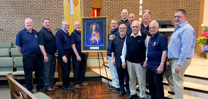Knights from Msgr. Sylvester Borusky Council 10243 in Green Bay, Wis., gather with Father Adam Bradley, pastor and council chaplain, around the Sacred Heart pilgrim icon after a Holy Hour dedicated to the Sacred Heart of Jesus at St. Bernard Parish.