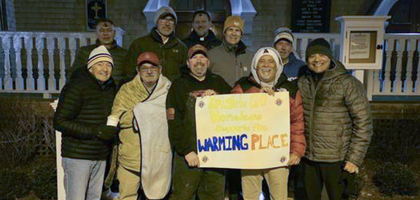 Mass., stand with Father John Murray, pastor and in front of St. Mary’s Church during their “Knights Go Homeless” event on Ash Wednesday 2025.