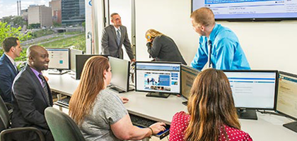 Loan management office employees working on computers.