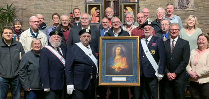 Members of Father Andrew Kunkler Council 2158 in Minster, Ohio, and others gather around the Order’s Sacred Heart pilgrim icon at Holy Redeemer Church in New Bremen after the pilgrim icon prayer service organized by Council 2158. 
