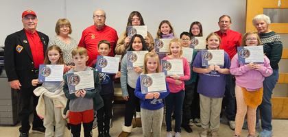 Knights from Watertown (Wis.) Council 1478 and staff from Watertown Catholic School stand with some students who participated in the council’s Keep Christ in Christmas poster contest.