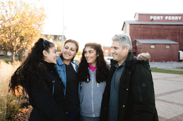 Happy family stands outside together