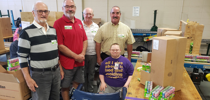 Knights from St. Mary Council 6547 in Milton, Wis., stand with a client from KANDU Industries, a local organization that provides daily living skills training, adult day services, memory care and job opportunities to people with disabilities. 