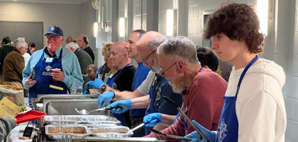 Knights from Coffee Run Council 6768 in Hockessin, Del., parish youth and other volunteers serve food during a council Lenten fish fry at St. Mary of the Assumption Parish. 