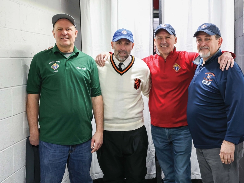 Angelo D&rsquo;Amico (second from left), a former NHL linesman, stands with members of George F. Monaghan Council 2690 in Livonia, Mich.