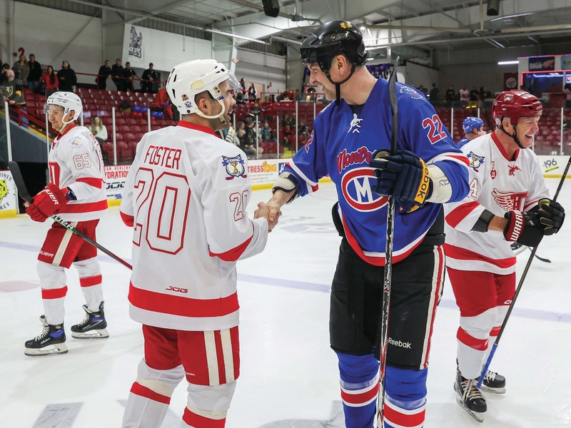 Alex Foster (left) greets John Scott after the alumni game.