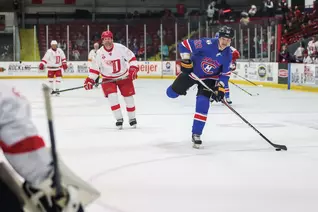 John Scott (right), an eight-year veteran of the NHL, takes a shot on goal during the 2025 NHL Alumni Game.