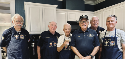Knights from Msgr. Don H. Hughes Assembly 2392 in Tucson, Ariz., stand with meals they prepared for guests of Fisher House, which provides free, temporary lodging for family and friends of veterans receiving inpatient care at the local VA hospital. The Knights prepare meals there eight times a year.