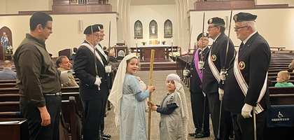 Members of Father Nicholas Schneider Assembly 3188 and Father Charles E. Mentrup Council 14400 in Springboro, Ohio, provide an honor guard for a Las Posadas procession before an evening Mass at St. Mary of the Assumption Parish. 