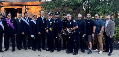 Members of St. Barnabas Council 5559, Moses Cleaveland Assembly 800 and Pope John XXIII Assembly 1765 gather with first responders outside St. Barnabas Church in Northfield, Ohio, after a Mass to honor first responders. About 650 people attended the Mass, including 13 representatives from local agencies. Afterward, attendees visited with the first responders and viewed law enforcement vehicles provided for display by the sheriff and police departments.