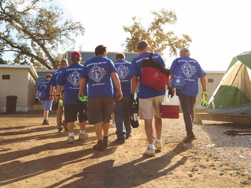 Florida Knights gather for a workday to construct tent platforms at a homeless shelter in Clearwater, Fla.