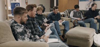 Young College Knights sit on couches and laugh