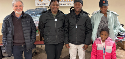 Charlie Allen (left), lecturer of St. Joseph the Worker Council 13356 in Victoria, British Columbia, gathers with an immigrant family from Barbados after presenting them with new jackets during the council’s coat distribution. The council worked with the local Society of St. Vincent de Paul conference and the Intercultural Association of Greater Victoria to distribute nearly 300 coats — including nearly 100 purchased through the Knights of Columbus Coats for Kids program — to families in need.