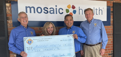 Grand Knight Marcus Agustin (second from right) and other members of Edwardsville (Ill.) Council 1143 present a $15,000 check to Kathy Lesnoff, CEO of Mosaic Health, which operates two local pregnancy resource centers. Through the Ultrasound Initiative, the Supreme Council matched Council 1143’s donation, for a total of $30,000 toward the purchase of a new ultrasound machine for Mosaic.