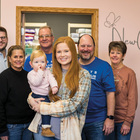 Karlee Jones and her daughter, Wrenlee, stand with board members and volunteers of New Creation Pregnancy Resource Center in Carroll, Iowa