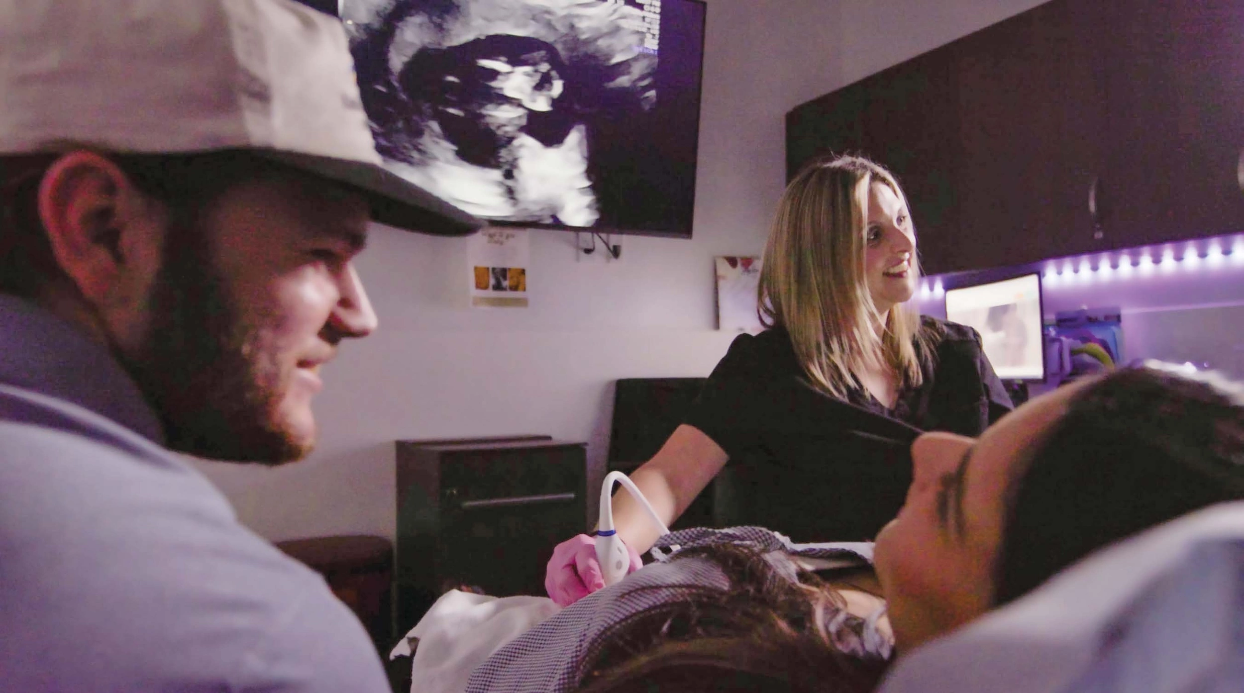 A sonographer at the St. John Paul II Life Center and Vitae Clinic in Austin, Texas, shows a couple their unborn child.