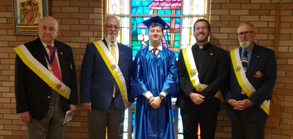 Officers from Sacred Heart of Mary Council 7622 in Jermyn, Pa., stand with Michael Peregrim, a graduating eighth grader from LaSalle Academy in Jessup, after awarding him a $1,000 scholarship toward tuition at a local Catholic high school. 