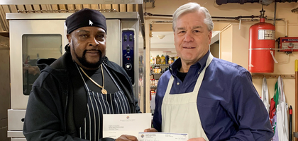 Michael Schuler (right) of Mother Seton Council 15540 in Three Bridges, N.J., presents a donation of $500 to Chef Curtis McNair of Elijah’s Promise, a community kitchen that provides more than 375,000 meals each year to people experiencing food insecurity, as well as other community resources.