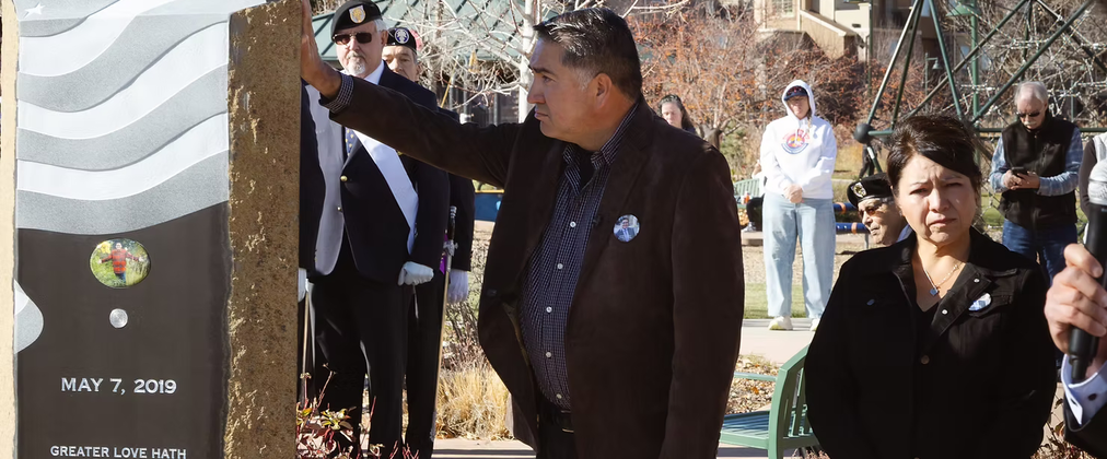 John Castillo, Kendrick’s father, touches a newly unveiled memorial to Kendrick Castillo in Highlands Ranch, Colo., Nov. 14.  (Photo by Neil McDonough / Denver Catholic)