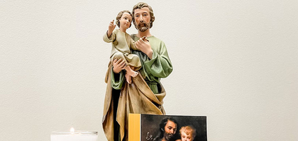 With A Fathers Heart is pictured with a statue of Joseph and Jesus.