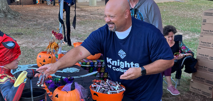 Eric Long of Archbishop John L. May Council 11480 in Enterprise, Ala., hands out candy during the Enterprise Parks and Recreation Department’s annual Spooky in the Park event. The council participated in the event for the second consecutive year, giving candy to more than 3,000 attendees.