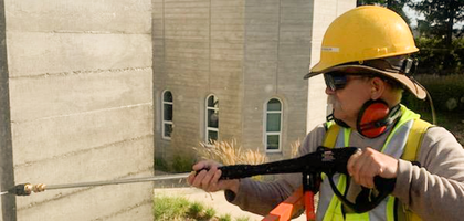 Grand Knight Rigo Moreno of Holy Redeemer Council 12899 in Vancouver, Wash., pressure washes one of the walls of Holy Redeemer Church.