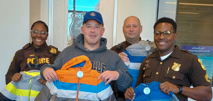 Community Director Peter Seely of Coffee Run Council 6768 in Hockessin, Del., presents New Castle County Police officers with jackets from the council’s 2025 Coats for Kids campaign. The council raised more than $7,000 to purchase more than 450 coats, 600 hats and 600 pairs of gloves, which were distributed among several community agencies and schools.