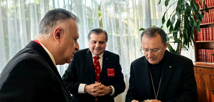 State Deputy Alejandro Arroyo (left) of Mexico South presents an encyclopedia on Our Lady of Guadalupe to Archbishop Joseph Spiteri, apostolic nuncio to Mexico, as Supreme Director Jorge Estrada looks on. 