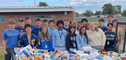 Grand Knight Mike Abbate (back, left) of Ascension of Our Lord Council 9623 in LaPlace, La., and students from St. Charles Catholic High School gather behind a trailer filled with Thanksgiving food baskets. The council distributed 50 baskets — including canned food, household essentials and more — to families in need and homebound community members. The council has organized this project for about 40 years.