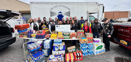 Knights and family members from Our Lady of the Rosary Council 4428 in Deer Park, N.Y., assemble around a council donation to the United Veterans Beacon House in Bay Shore. 