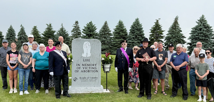 Members of Father Carey Council 5569 and Mother Teresa Assembly 2812 in Rosemount, Minn., join parishioners of St. Joseph Church at a memorial for victims of abortion in St. Joseph Cemetery.