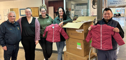 Knights from Our Lady of the Valley Council 10889 in Maple Ridge, British Columbia, and staff from Eric Langton Elementary School display some of the more than 140 winter jackets donated to the school through the Knights of Columbus Coats for Kids program. 