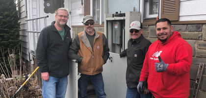 Knights from South Plainfield (N.J.) Council 6203 and other volunteers assemble near a new wheelchair ramp and lift they installed at the home of Maria Niemeyer, a parishioner of Our Lady of Czestochowa Church who needed a more accessible entrance to her home.
