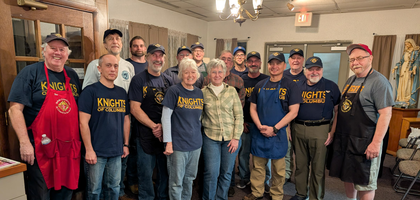 Knights and family members from Norfolk (Va.) Council 367 gather during a shrimp dinner fundraiser to benefit St. Pius X Catholic School. They served 200 meals at the event, raising a little over $2,100 for the school.