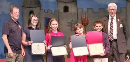 Grand Knight Kevin Musser (left) and Bill Hewitt, members of Aldo J. Zazzi Council 6992 in Kingsport, Tenn., present awards to the first-, second- and third-place winners of the council’s essay contest for students at St. Dominic School.