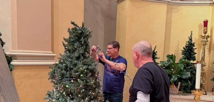 Deputy Grand Knight Vince Stollar (left) and Randy Offenberger of Marietta (Ohio) Council 478 decorate a Christmas tree at the Basilica of St. Mary of the Assumption. About 20 Knights and volunteers spent four hours decorating and setting up Christmas trees, the Nativity scene and poinsettias. Knights have helped decorate the basilica for Christmas for more than 15 years.