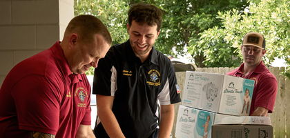Grand Knight Cliff Bigner (left) and other members of Archbishop Joseph F. Rummel Council 5747 in Chalmette, La., deliver $300 worth of diapers to Woman’s New Life Clinic in New Orleans.