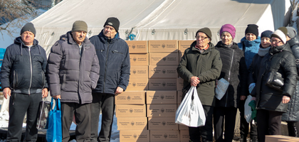 Internally displaced people gather at the entrance of St. Nicholas the Wonderworker Church in Kharkiv for an aid distribution organized by the Ukraine State Council.