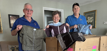 Jim Range (left) and Past Grand Knight Steve Gearhart of Michael O’Connor Council 5026 in Beaufort, S.C., and Sister Canice Adams of the Sisters of Sts. Cyril and Methodius display some of the winter jackets donated by the council to the St. Francis Center on St. Helena Island.