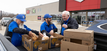 Members of Jubinville Council 3579 in Lorette, Manitoba, load food donated by a local grocery co-op for the Taché Food Resource Centre, which aids more than 100 families. 