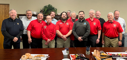 Knights from Cathedral of St. Peter Council 15746 in Belleville, Ill., gather with Deacon Levi James (front), a seminarian for the Diocese of Belleville and a brother Knight, and Father Godfrey Mullen (back, second from right), pastor and council chaplain, during one of the council’s recent Sunday fellowship gatherings after Mass. Twice a month, Council 15746 provides donuts and coffee for as many as 80 parishioners after morning Mass.