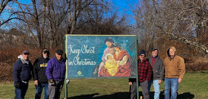 Grand Knight Richard DeAngelis (third from left) and members of Coeur de Leon Council 87 in Framingham, Mass., gather around one of the council’s Keep Christ in Christmas signs after installing it at St. George Catholic Church. For several years, the council has installed these signs at four local Catholic churches at the start of Advent, keeping them displayed until the week after the Epiphany.