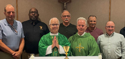 Knights from Marquette Assembly 1078 in Sioux Falls, S.D., gather with Father Dan Smith (left), chaplain to the South Dakota State Council and Sanford Hospital, and Deacon Mark Harriman, a member of Assembly 1078 who serves two local parishes, after a Mass at the hospital chapel honoring the assembly’s deceased members. Father Smith used a chalice gifted by the assembly with a memorial inscription honoring the deceased Knights.