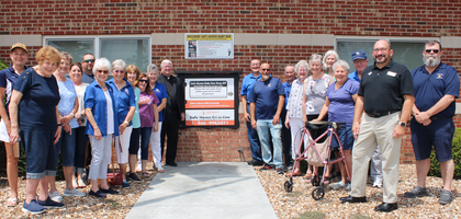Members of O’Fallon (Mo.) Council 2269 and its associated ladies’ auxiliary stand around a Safe Haven Baby Box at Fire Station #3 after it was blessed by Msgr. Dennis Stehly, senior associate pastor of Assumption of the Blessed Virgin Mary Parish and a brother Knight. Together, the groups raised $15,000 to purchase the box, which was installed in December 2024 and has since safely received at least one baby.