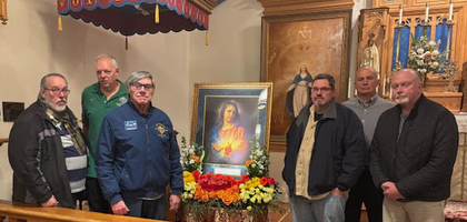 Knights from Bishop Navagh Council 5943 in Pequannock, N.J., stand around the Order’s icon of the Sacred Heart of Jesus after a Holy Hour dedicated to the Sacred Heart at Our Lady of Fatima Chapel. Father James Eichman, assistant administrator of the church and a brother Knight, led about 45 people in Eucharistic adoration and Benediction.
