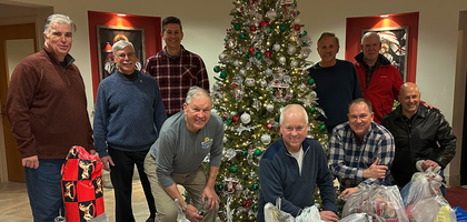 Knights from Jubilee Council 3294 in Flemington, N.J., gather behind bags of wrapped toys collected during the council’s annual Christmas toy drive at St. Magdalen Parish. More than 140 children from nearly 90 families received toys this year through Hope House, which serves families in need. The council has sponsored the event for more than 25 years.