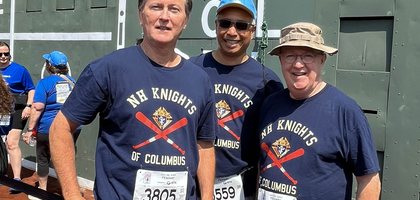 Grand Knight Dino Quintero (center) and members of Bishop Ernest J. Primeau Council 10896 in Merrimack, N.H., stand on the warning track at Fenway Park during the 2025 Run to Home Base charity run and walk, which supports healthcare programs for veterans. Organized by the Home Base Program, the event has received more than $13,000 from the council over the past three years.