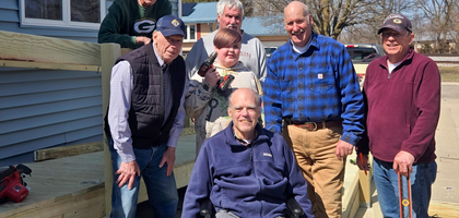 Knights from Watertown (Wis.) Council 1478 and Oconomowoc (Wis.) Council 2487 gather in front of a ramp they built for Larry Clark (center), a member of Council 1478 who previously served on Council 2487 as grand knight.