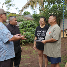 Knights speak with Josephine and Fredrick Diana, whose home in Waialua, Hawaii, was damaged by floodwaters. 